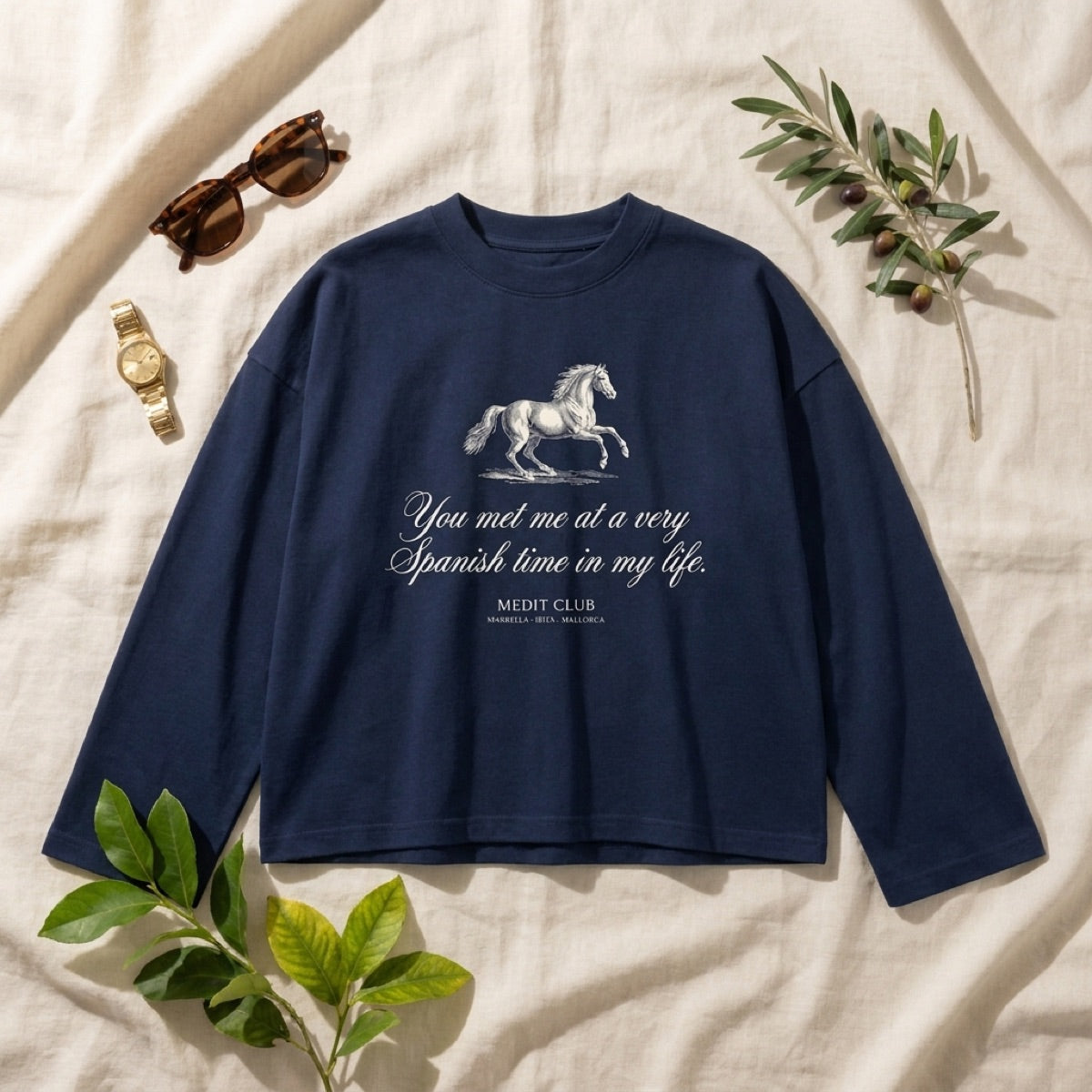 Spanish Time Longsleeve in Mallorca, laid flat on linen with olive branches