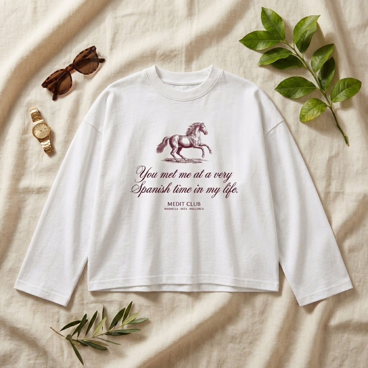 Spanish Time Longsleeve in Ibiza, laid flat on linen with olive branches