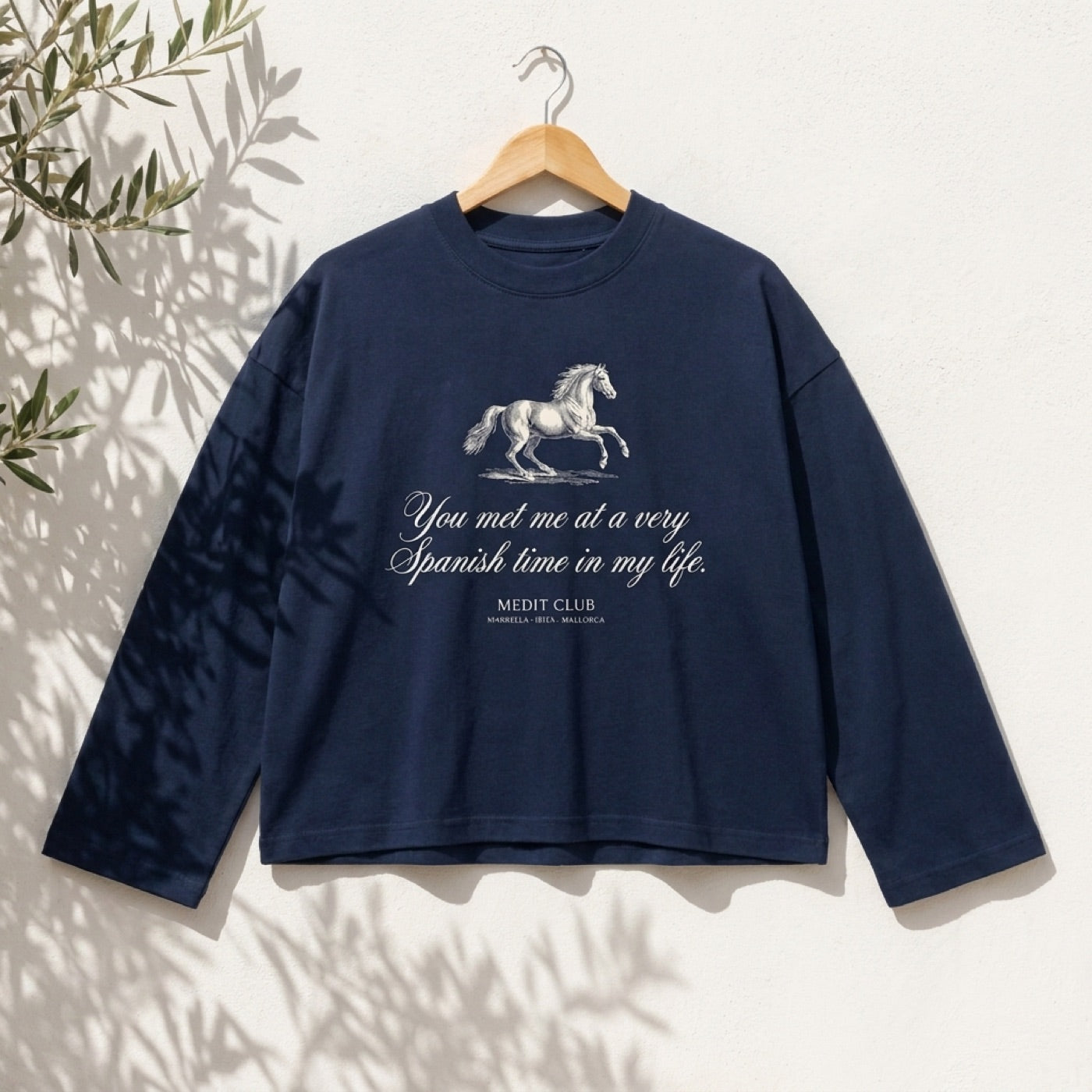 Spanish Time Longsleeve in Mallorca, on a wooden hanger